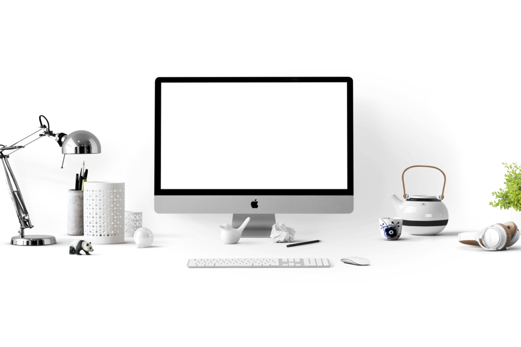 Desktop with a Mac computer and office utensils