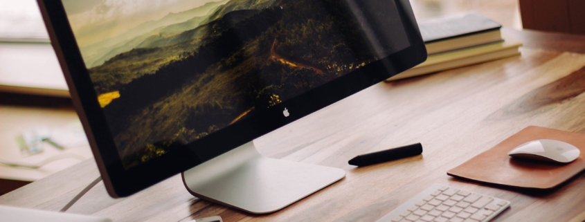 A modern Mac with a photo screensaver on a desktop