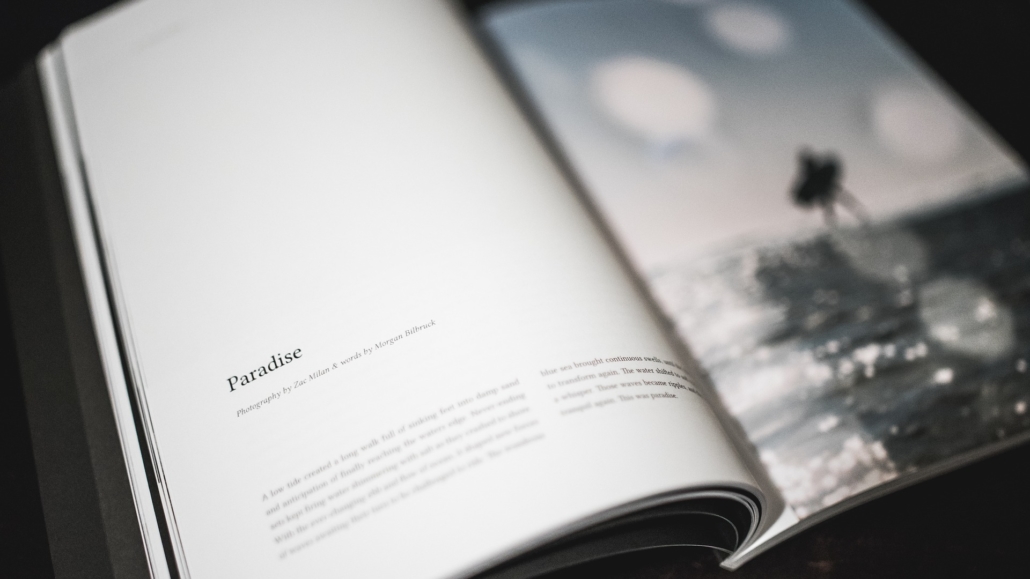 Open photo book in black and white with text on the left and a picture on the right