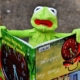 Kermit the frog holding a picture book with writing upside down