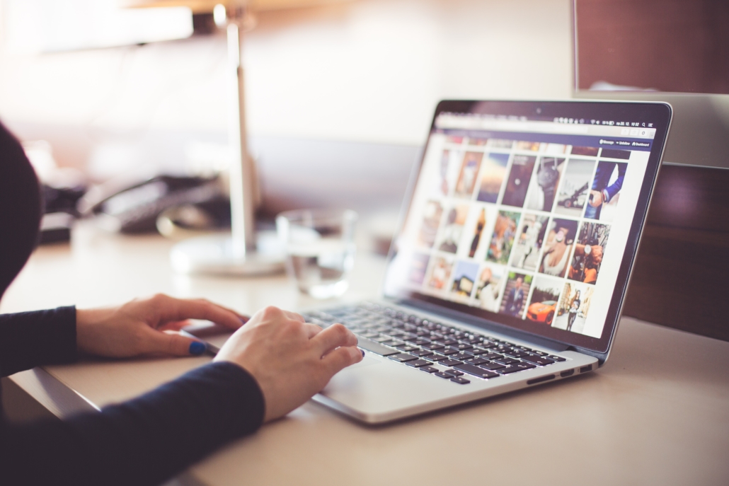 Person viewing and selecting photos on a computer