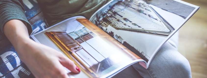 Photobook held by woman with pictures of a city